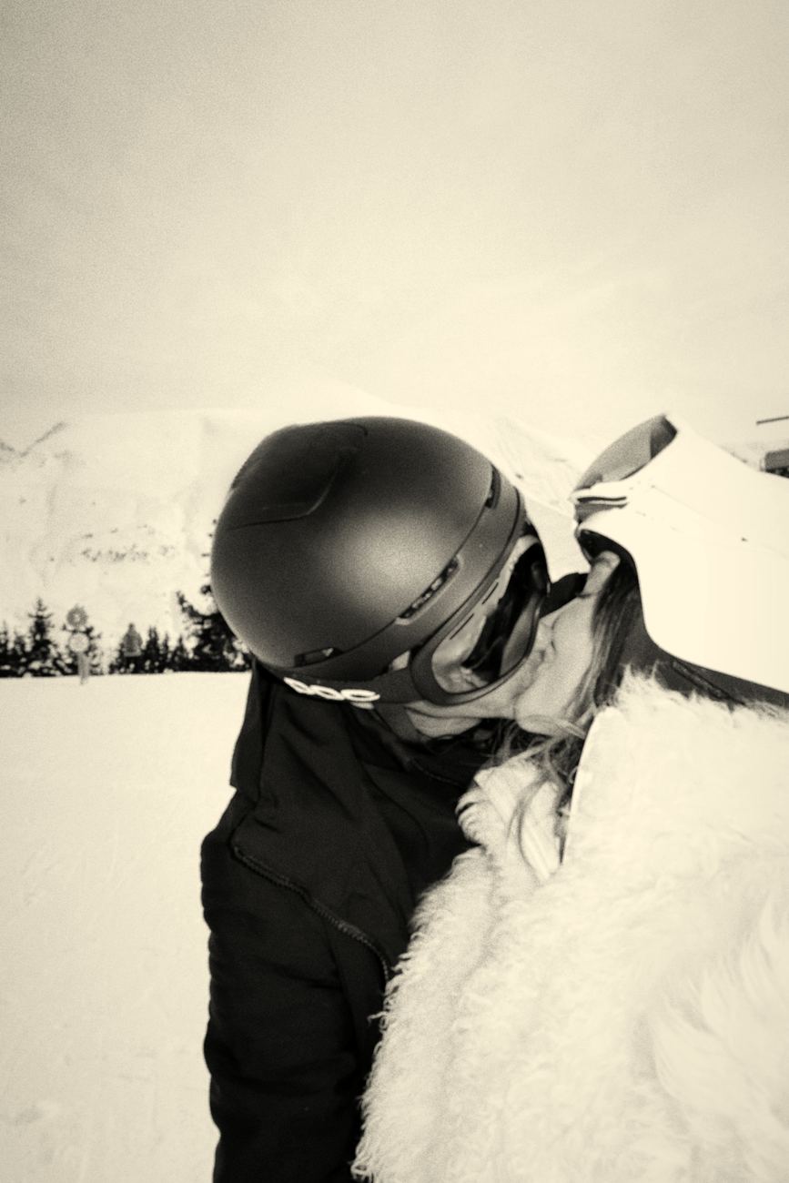 Mari and Graftan kissing in the snow, Graftan in a ski helmet