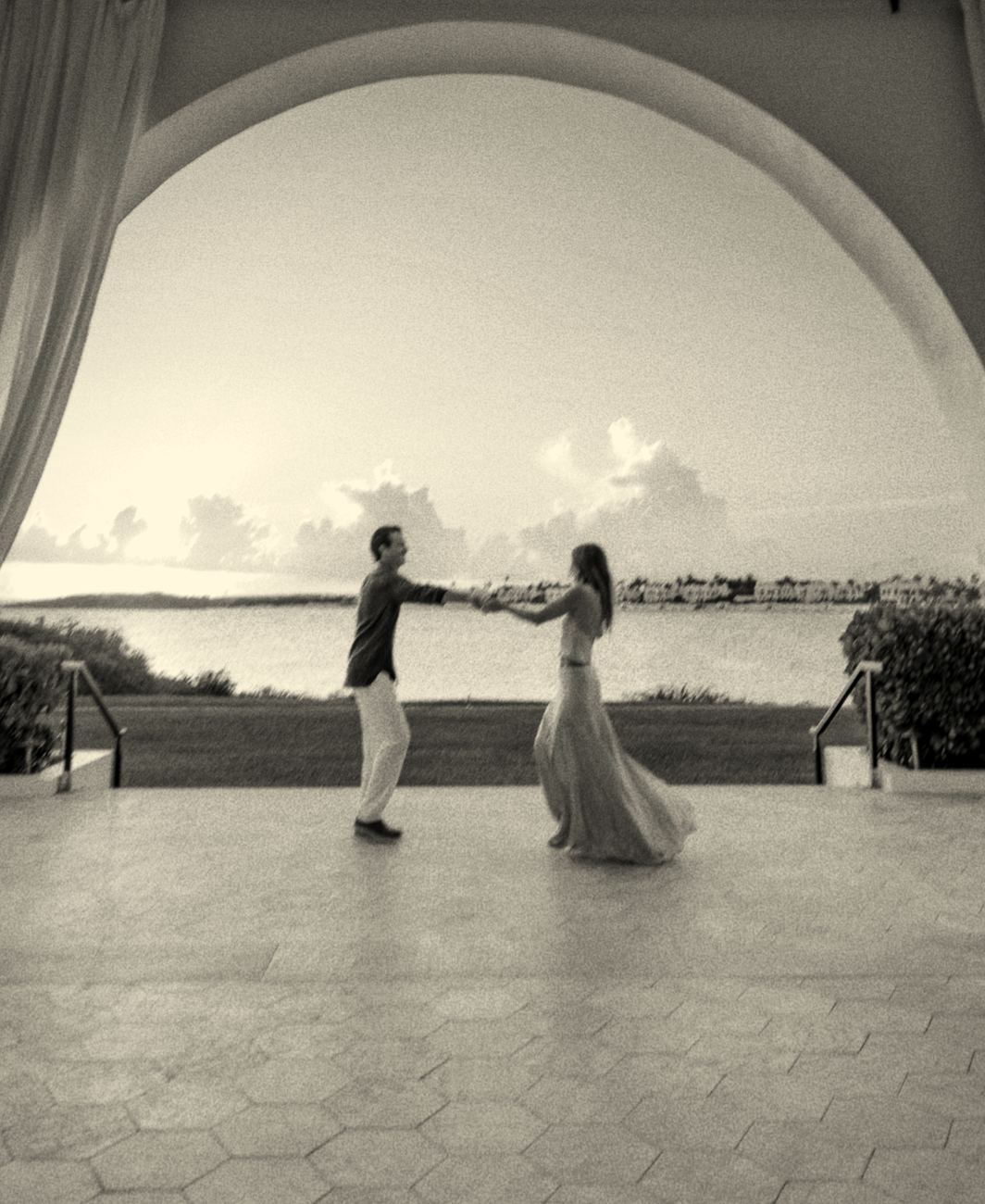 Dancing under an arch by the sea